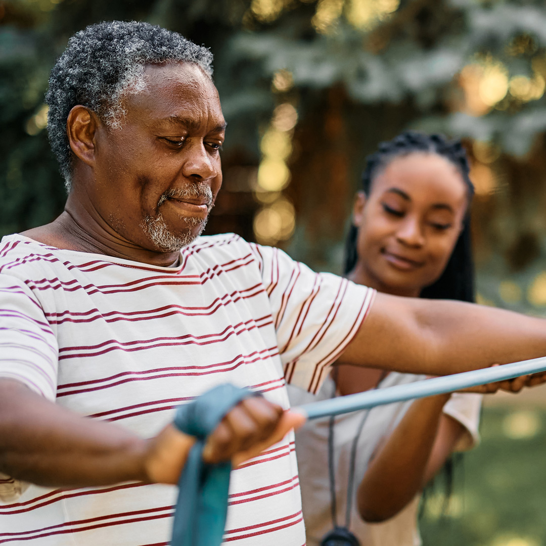 Man getting weight resistance training from woman trainer