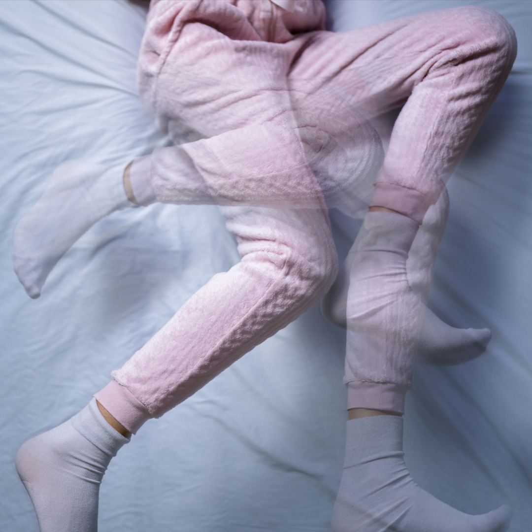 legs of a woman moving in bed