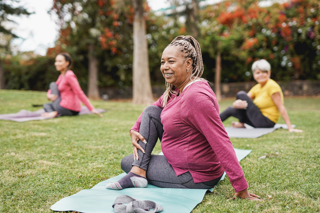 people taking a yoga class in the park