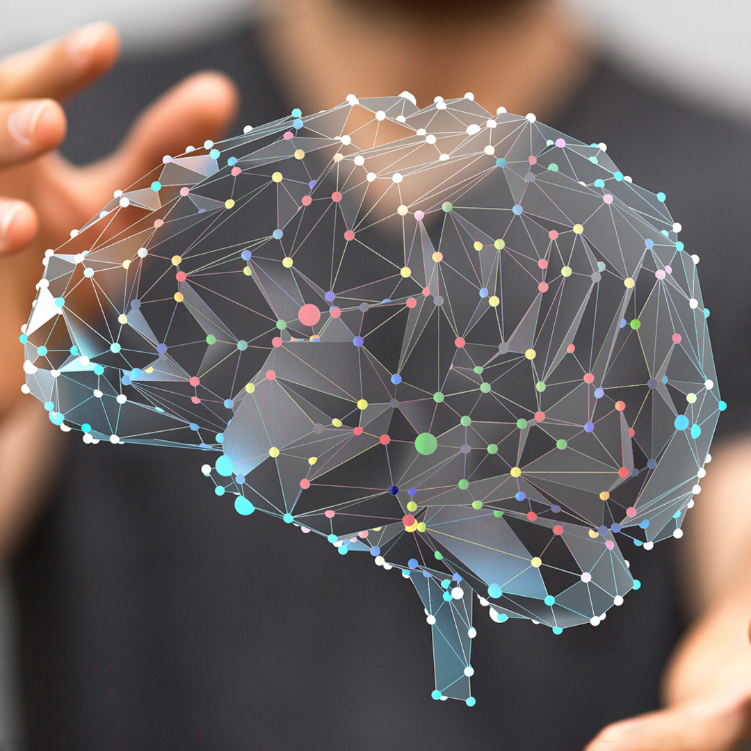 man holding computer image of brain