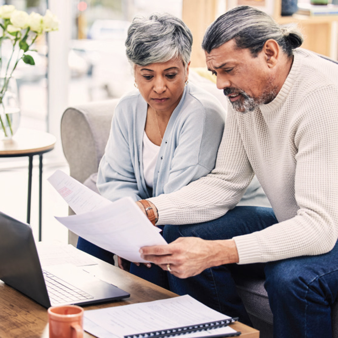 couple at home reviewing financial paperwork