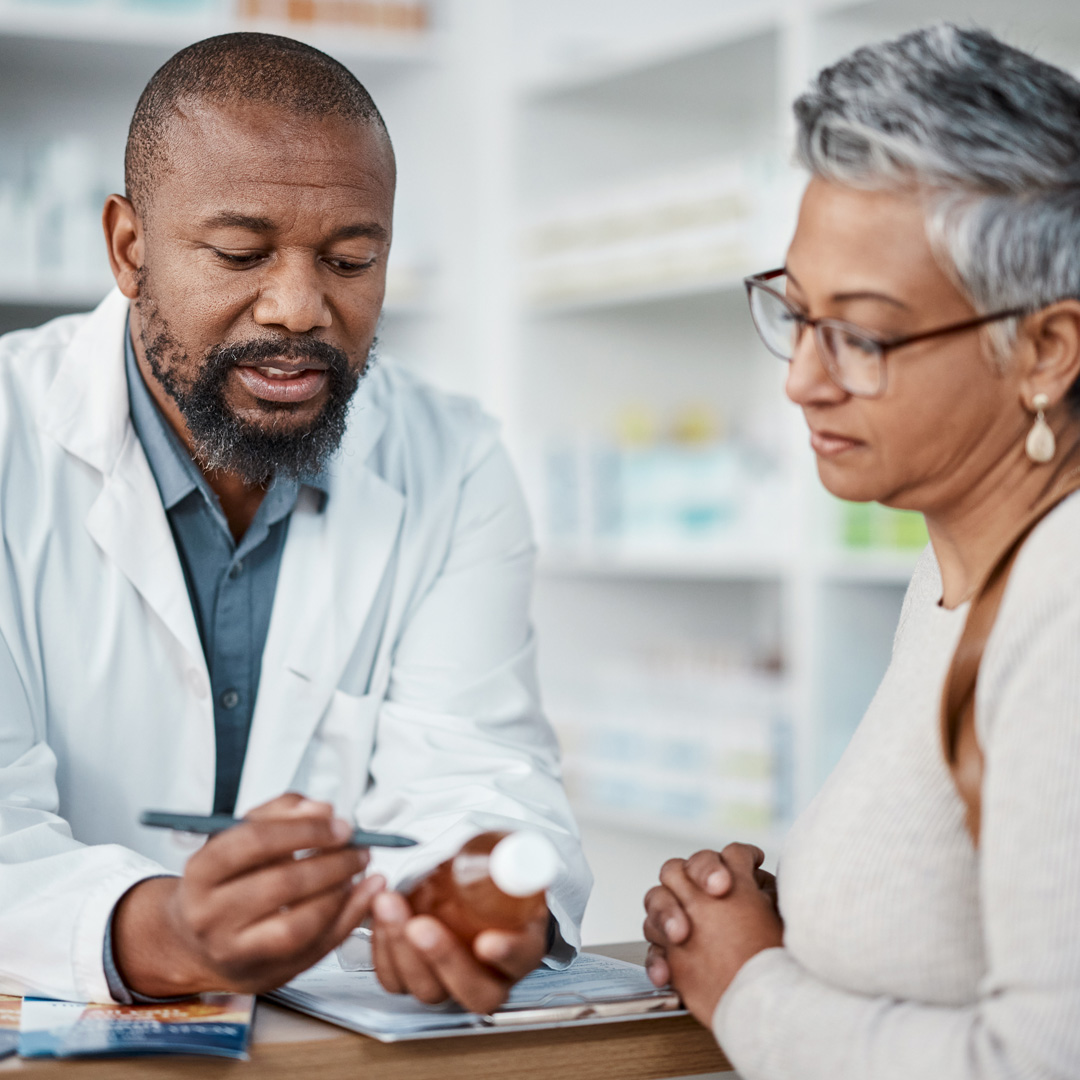 pharmacist explaining medicine details to woman