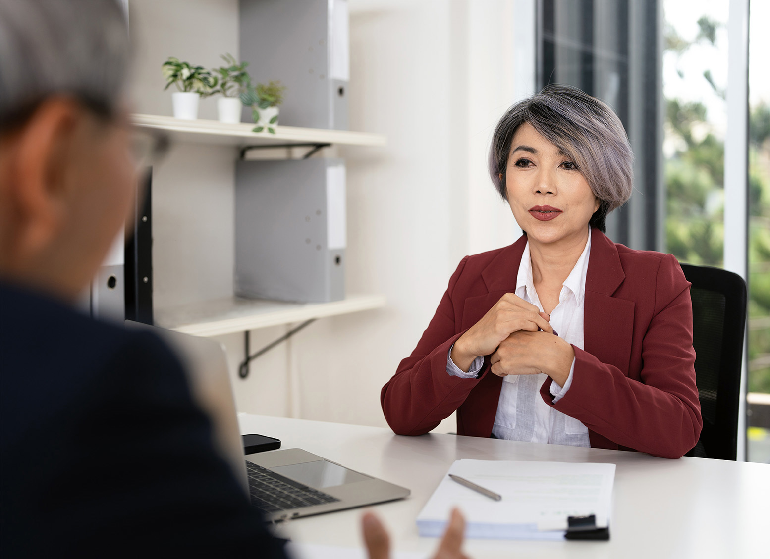 woman Care Counselor talking with a client in her office